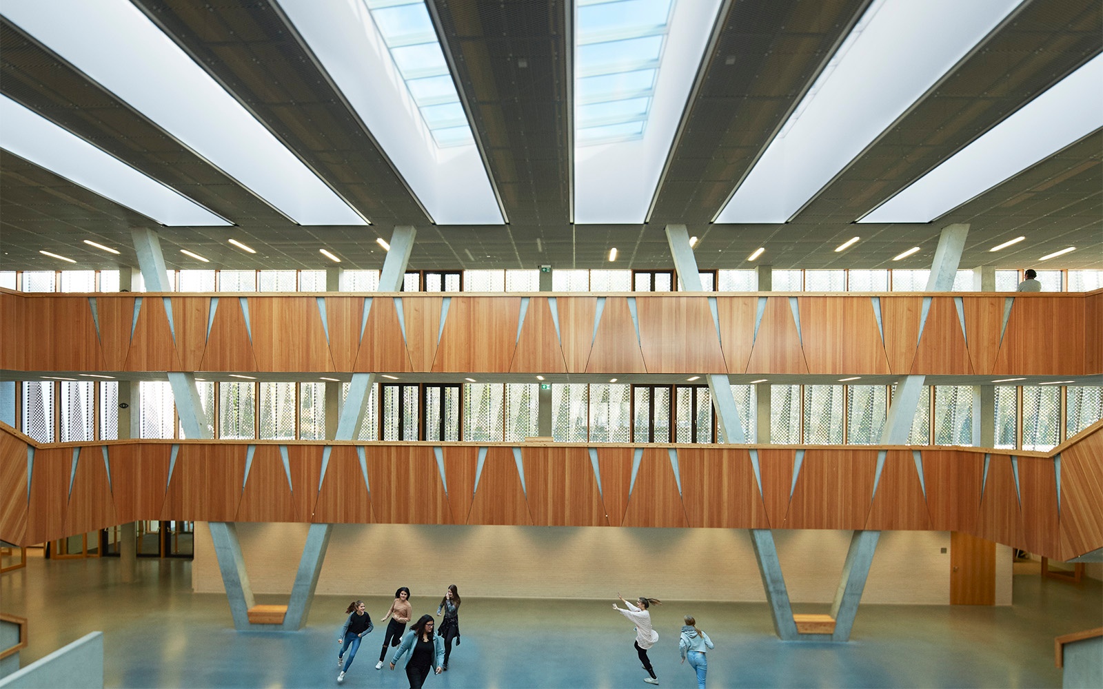 Open architectural school design with skylights for ventilation and natural lighting Open architectural school design with skylights for ventilation and natural lighting